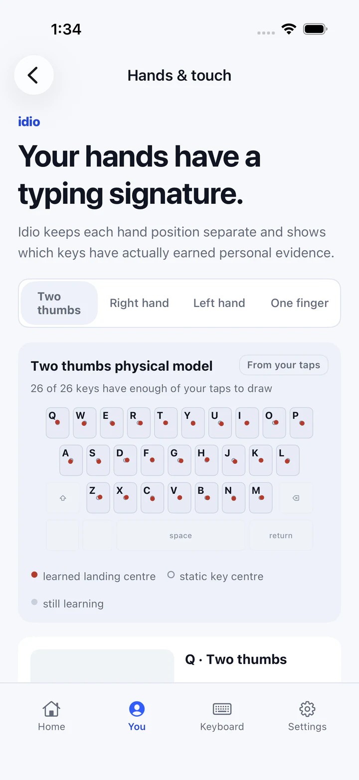 Idio Hands and touch screen showing a two-thumbs model with learned landing centres on all 26 letter keys.